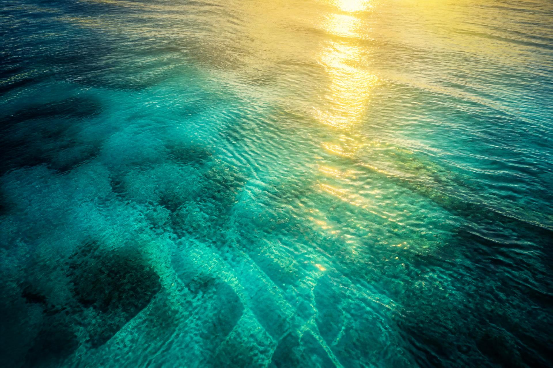 Turquoise ocean with golden sunlight